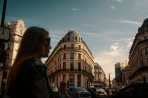 Woman walking on a parisian street with buildings.