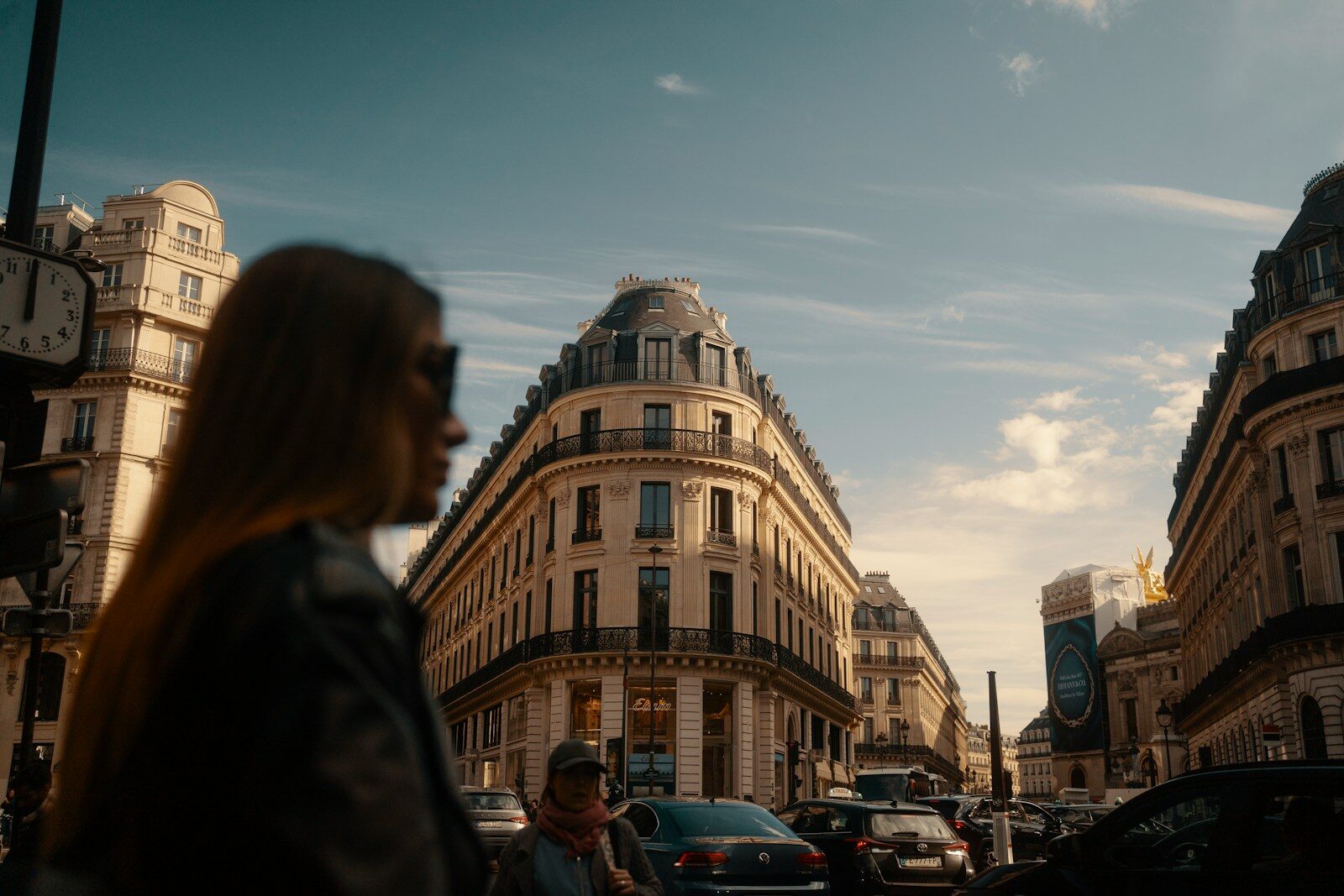 Woman walking on a parisian street with buildings.