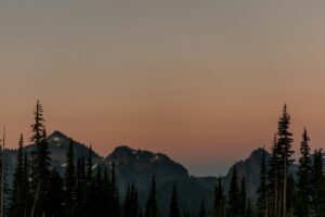Mountain peaks silhouetted against a dusky sky