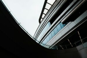 Curved modern building with glass facade and escalators