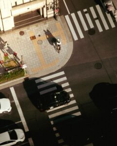 A cyclist rides through a city intersection