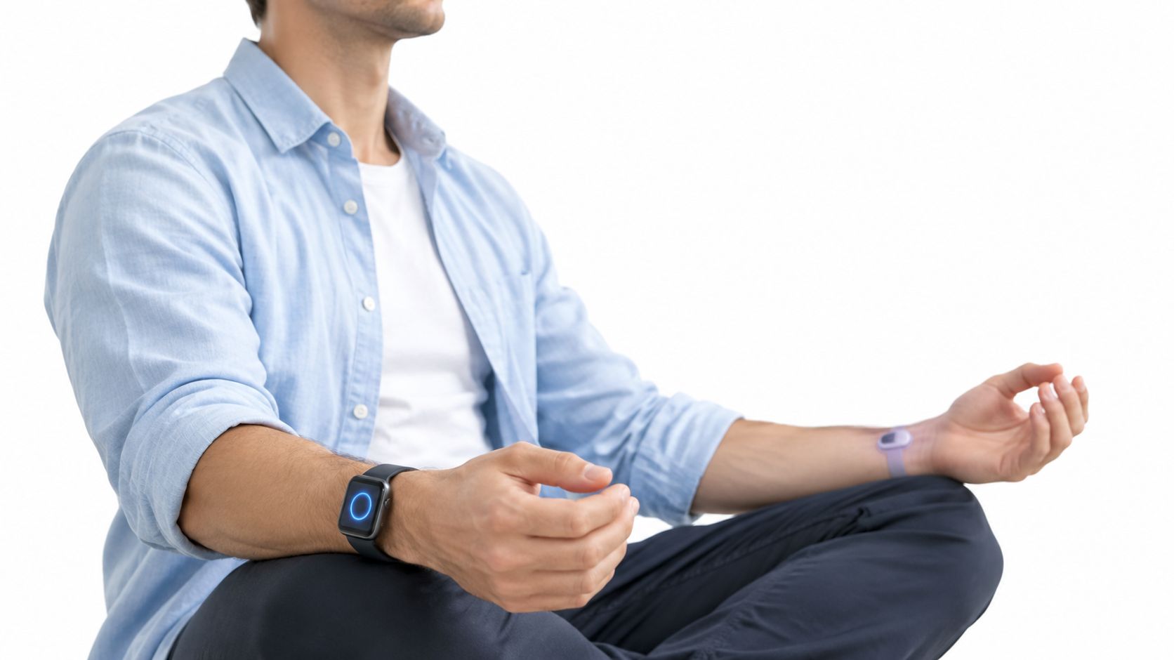 A man sitting in a cross-legged meditation pose while wearing a smartwatch and a health tracker.