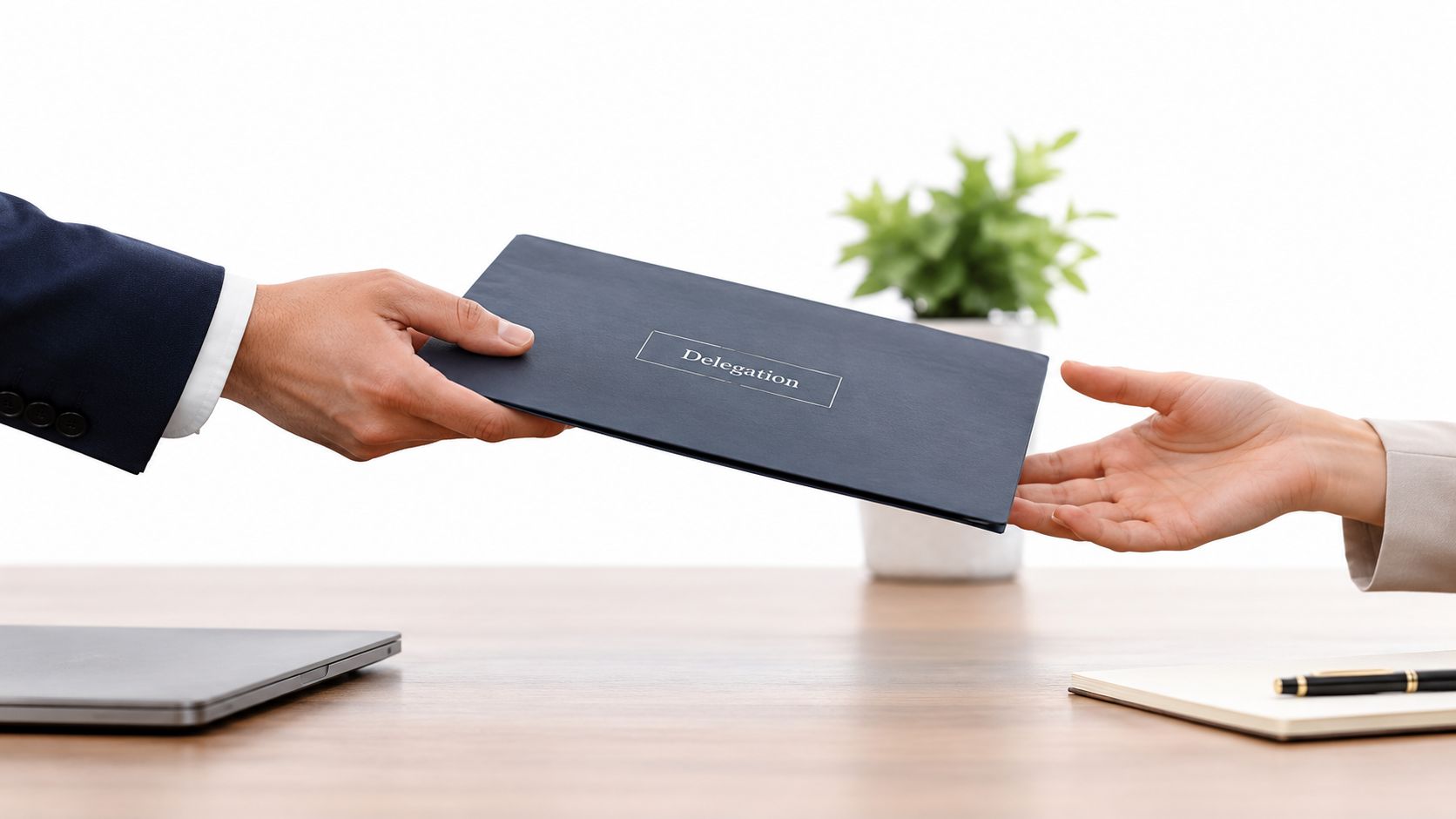 A professional business person handing a dark blue folder labeled Delegation to another person across a desk.
