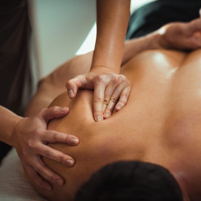 Physiotherapist,Massaging,Male,Patient,With,Injured,Shoulder,Blade,Muscle.,Sports