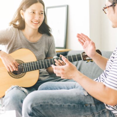 Couple,Playing,Acoustic,Guitar,sing,Folk,Song,Together,Sitting,On,Sofa